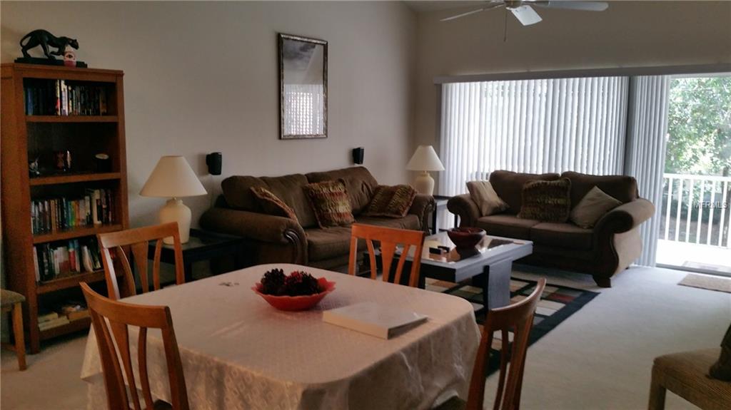 Living room with couch, table, and chairs.