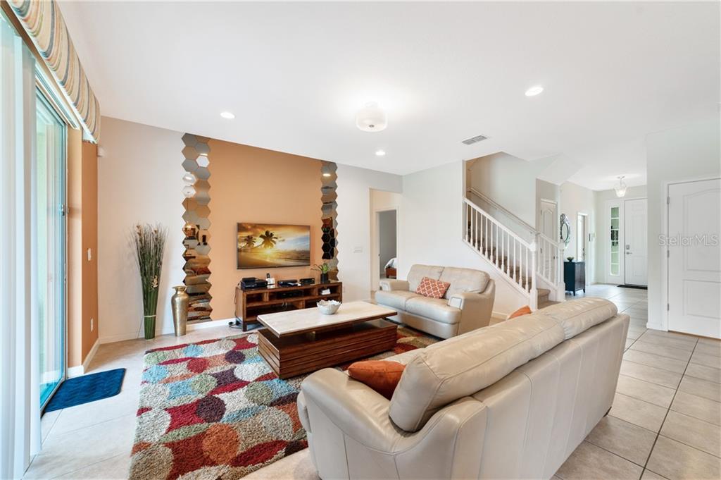 Living room with couches, TV, and rug.