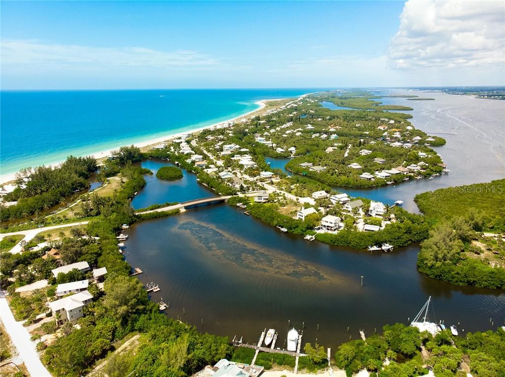 Aerial view of a coastal town with a bridge.