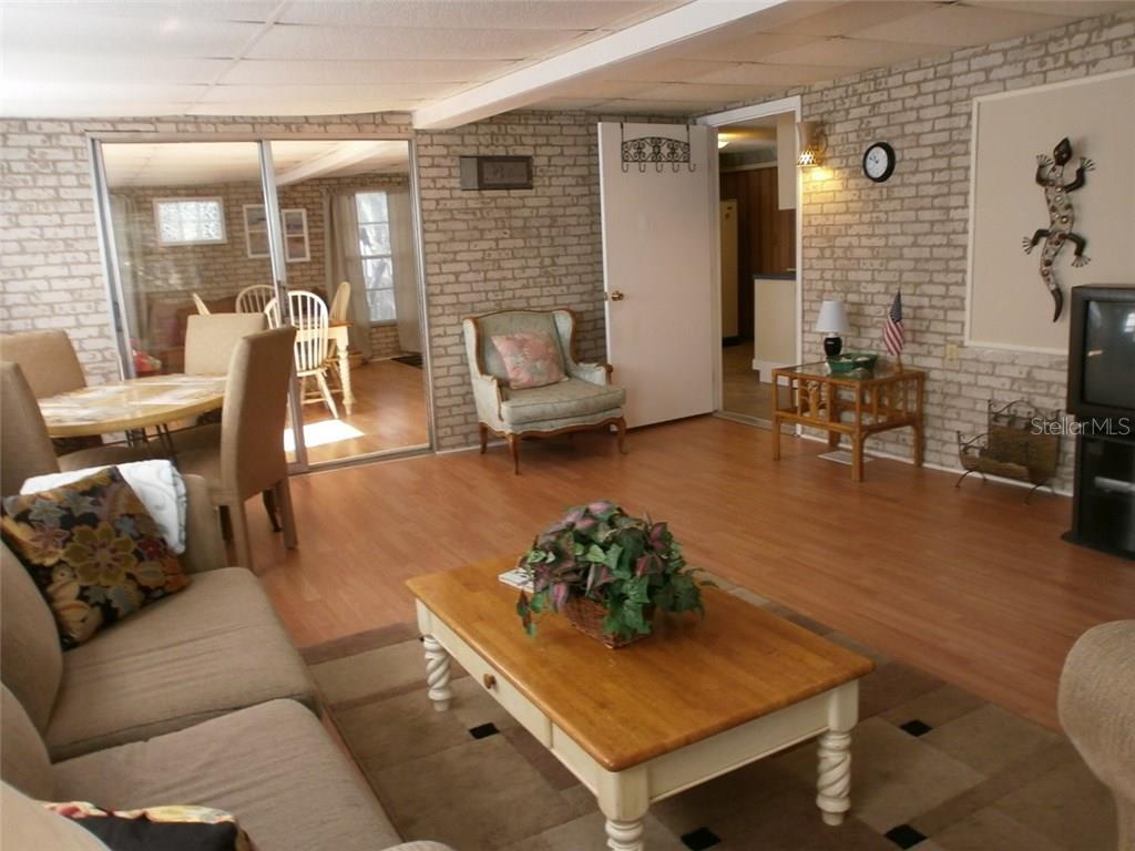 Living room with brick walls and a couch.