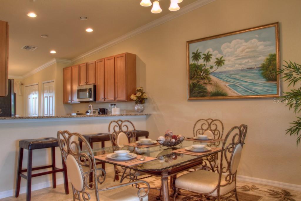 Dining room with beach scene painting.