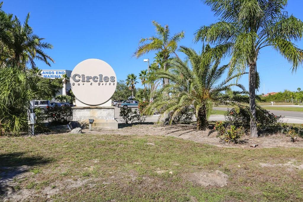 Circles Bar & Grill sign in front of palm trees.