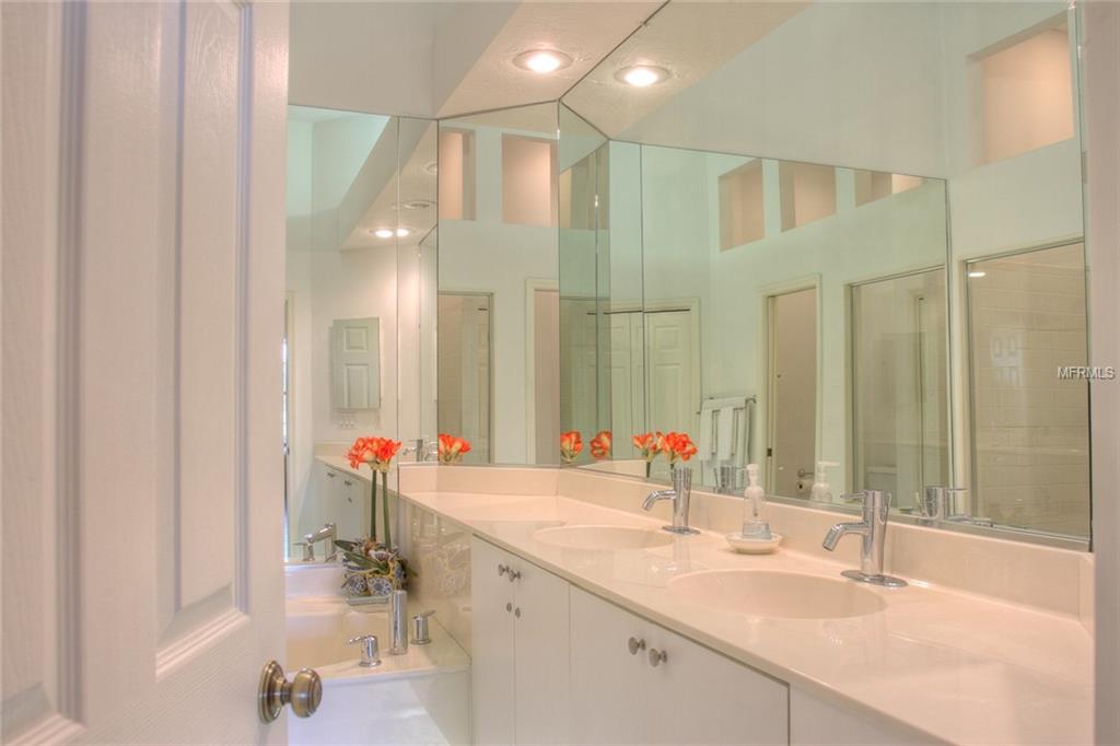 Bathroom with double vanity and mirror.