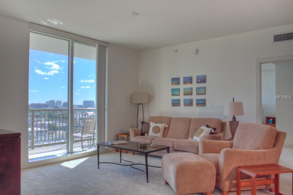 Living room with large windows and city view.