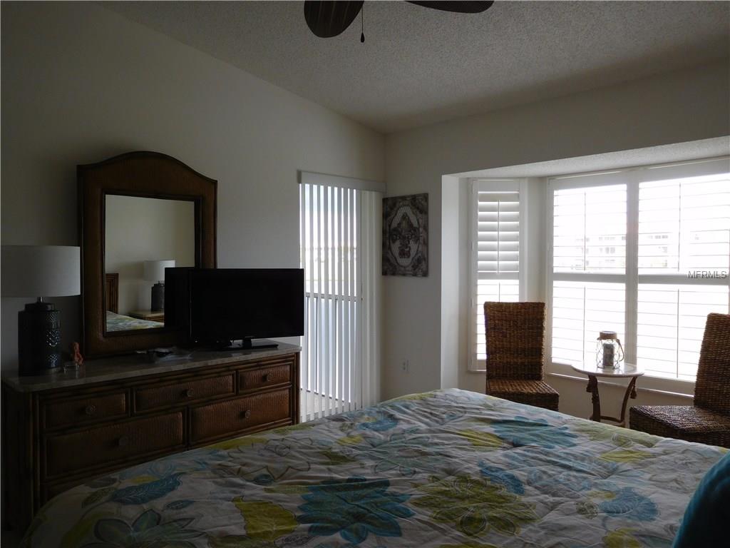 Bedroom with a TV and window view.