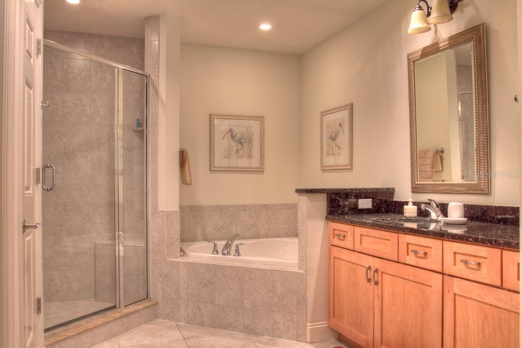 Modern bathroom with shower, tub, and vanity.