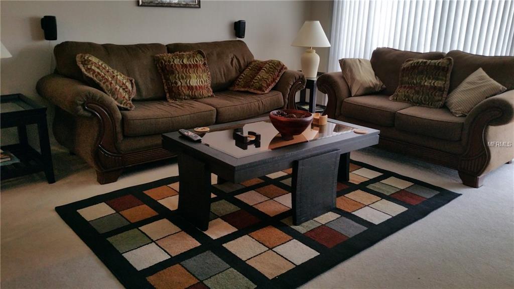 Living room with brown sofas and coffee table.