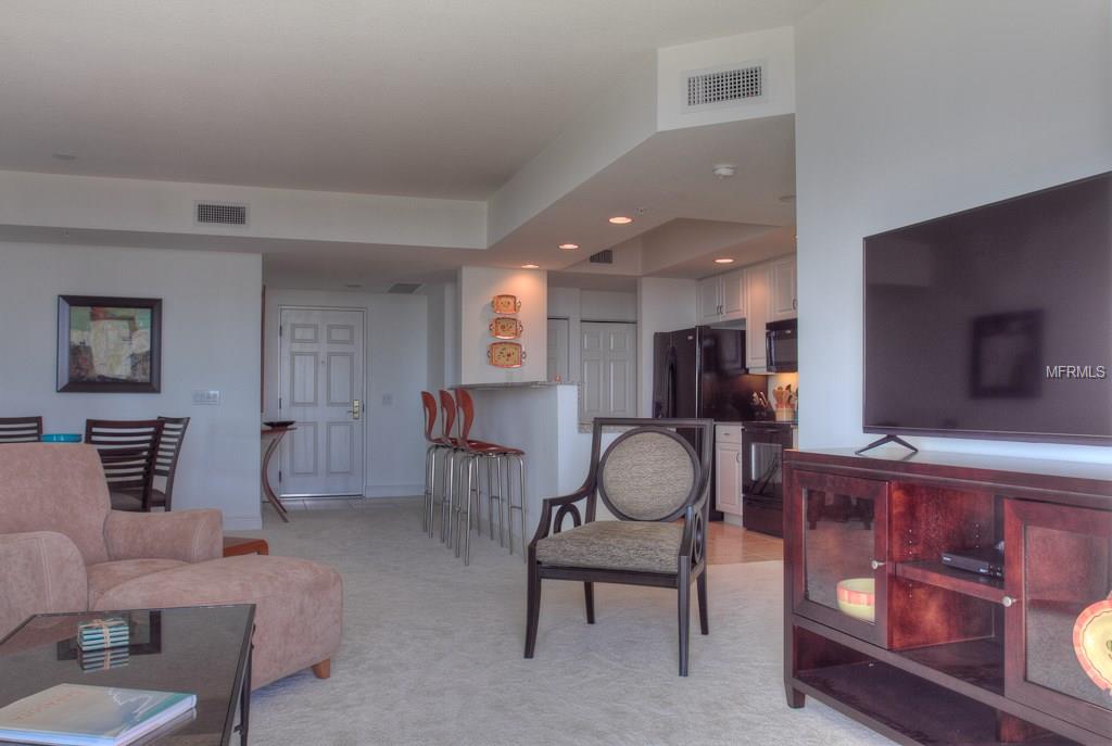 Living room with a tv and an armchair.