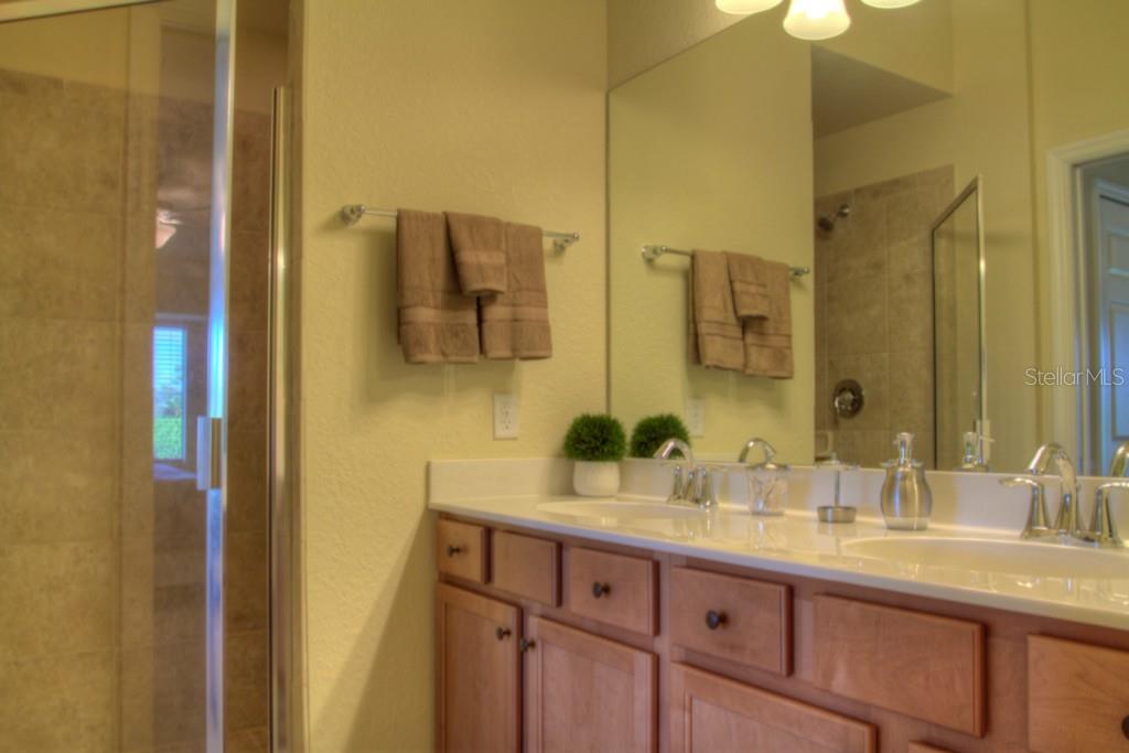 Bathroom with double sink and shower.