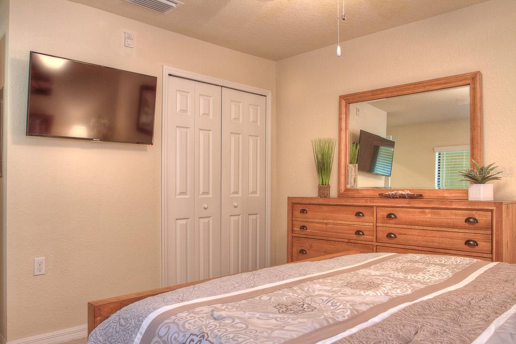 Bedroom with a TV, dresser, and bed.