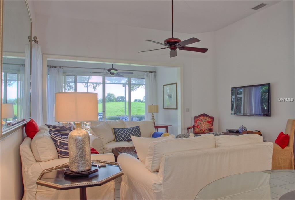 Living room with white furniture and a view.