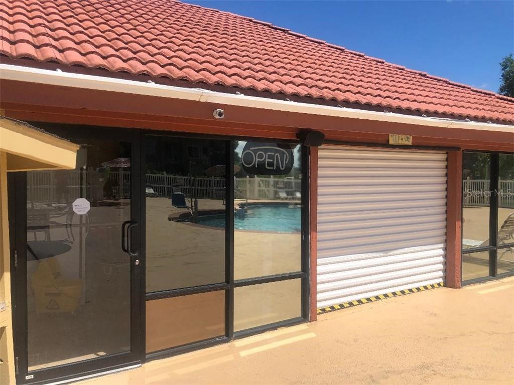 A building with an open door and a pool.