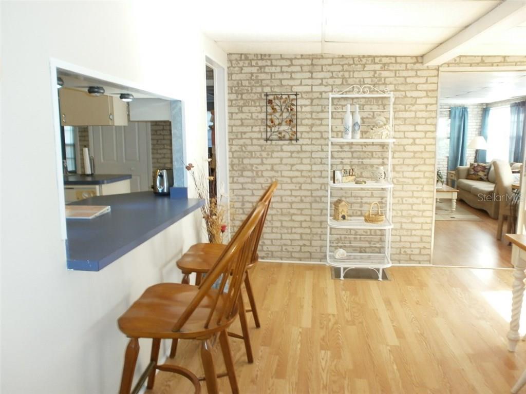 Kitchen counter with two wooden chairs.