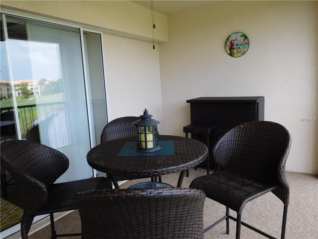 Outdoor patio with wicker furniture and a lantern.