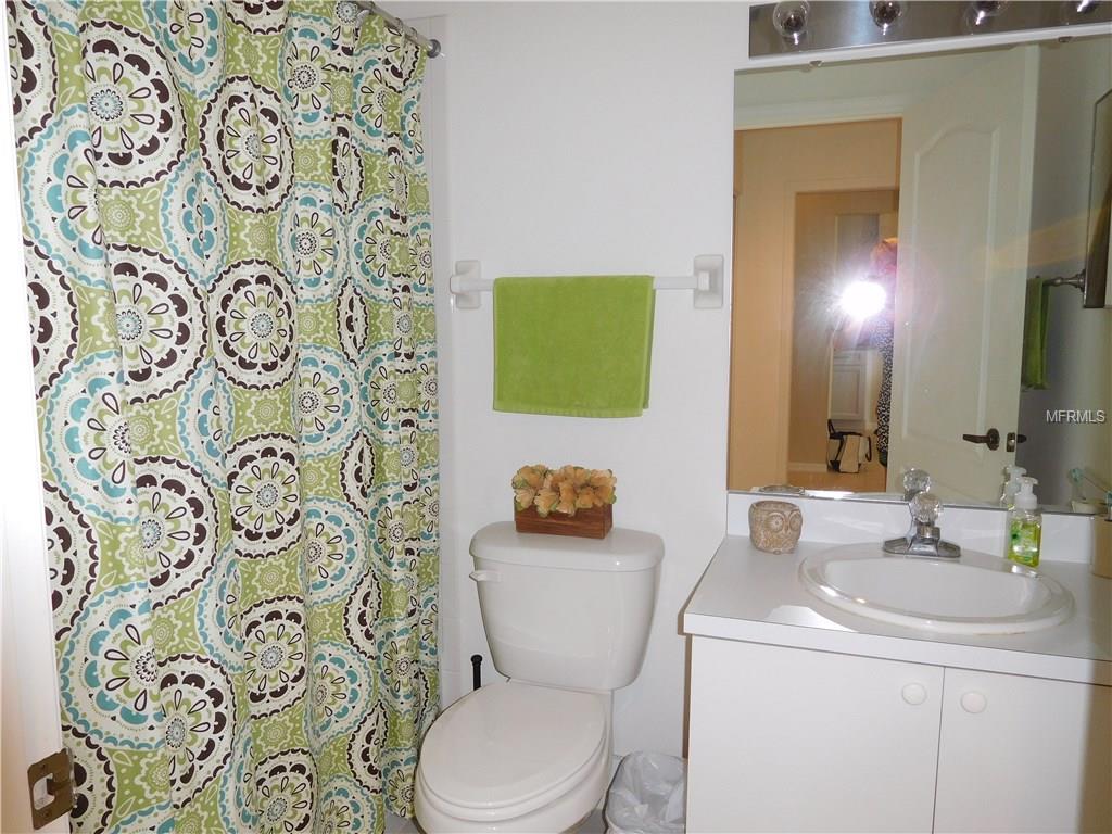 Bathroom with patterned shower curtain and sink.