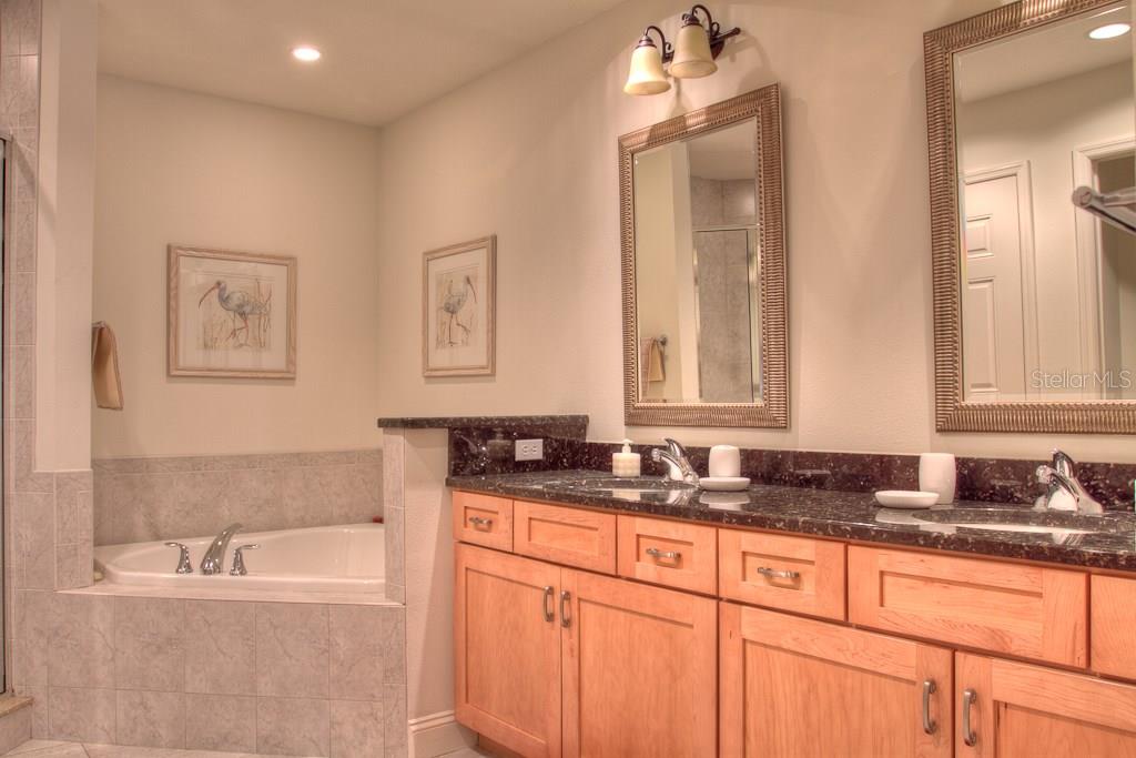 Bathroom with bathtub and double vanity.