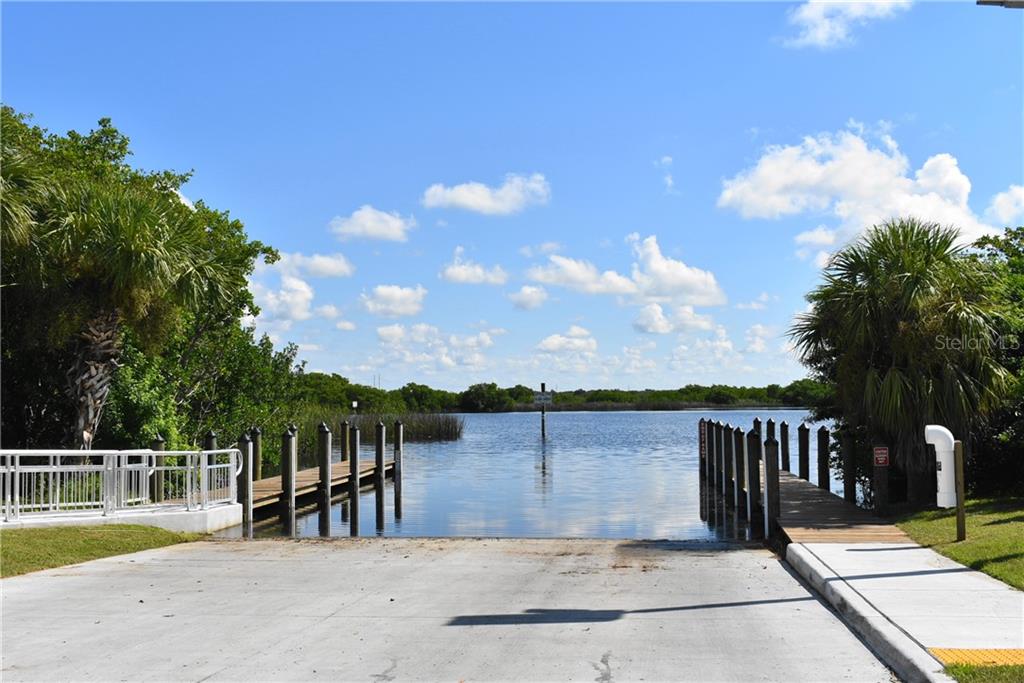 Boat ramp with dock leading to water.