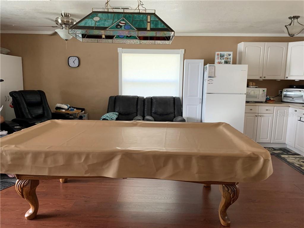 Brown pool table in a living room.