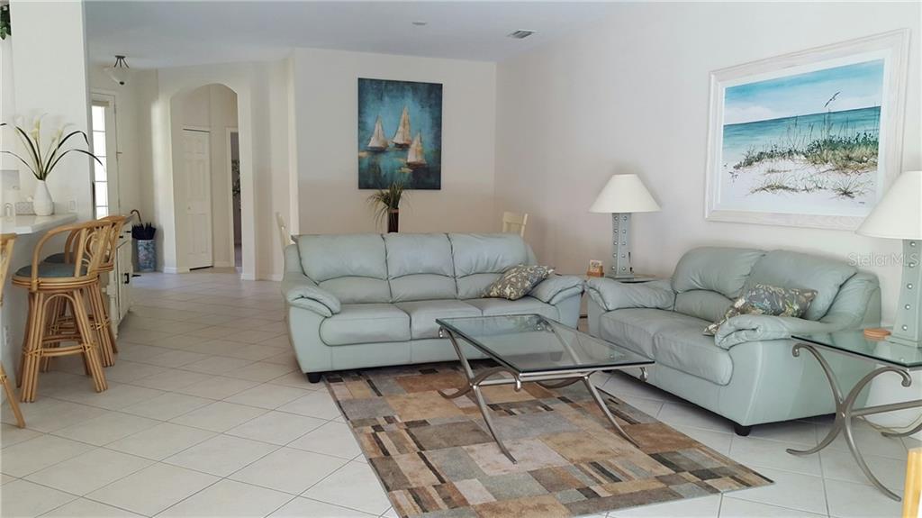 Living room with two blue sofas and a coffee table.