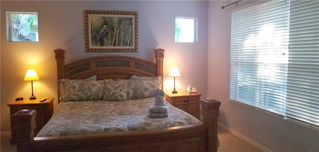 Bedroom with a king size bed and a picture on the wall.