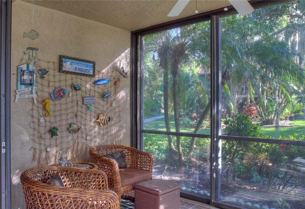 Beach-themed porch with wicker furniture.