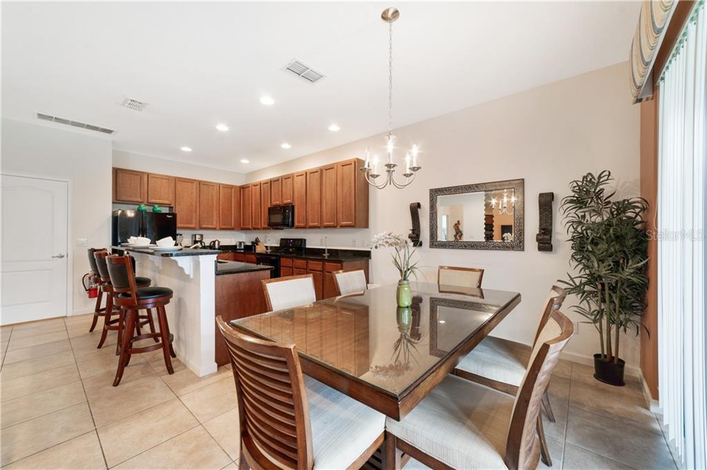 Kitchen and dining room with glass table.