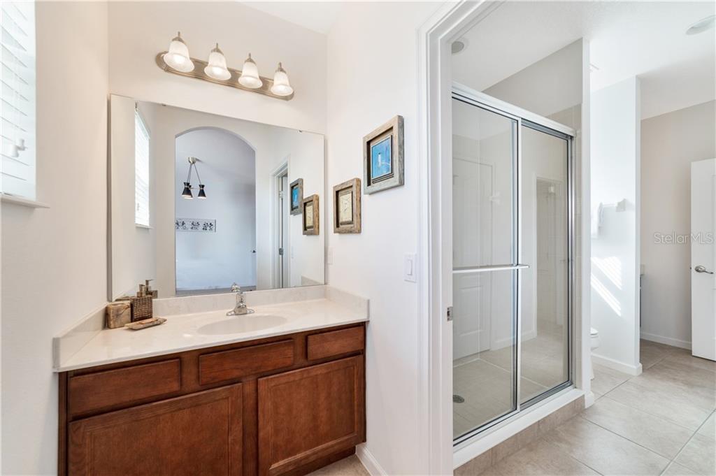 Bathroom with vanity and walk-in shower.