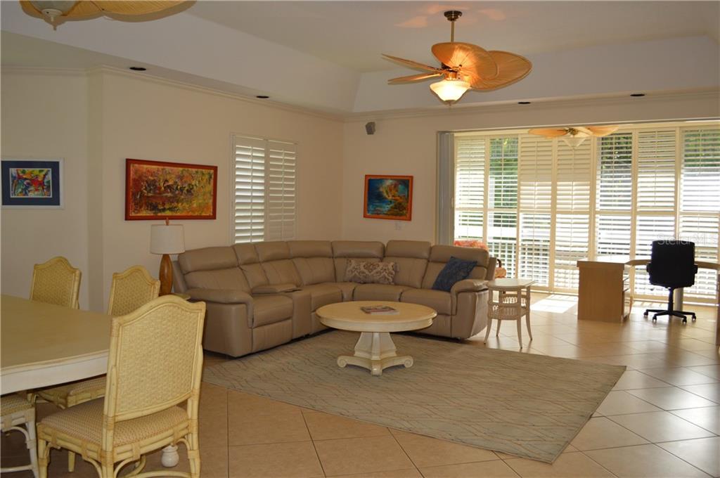 Living room with sectional sofa and ceiling fan.