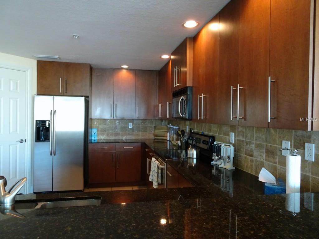 Modern kitchen with stainless steel appliances.