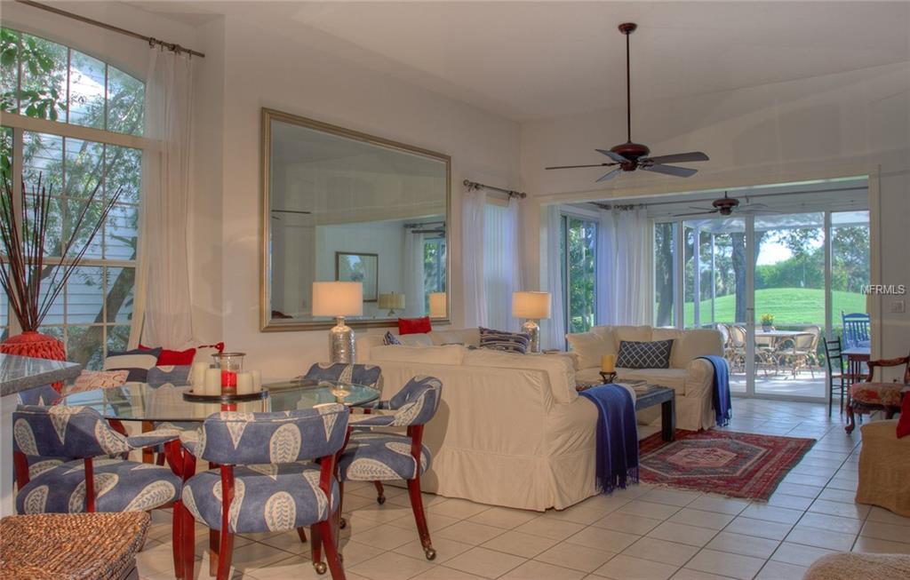 Living room with dining area and patio view.