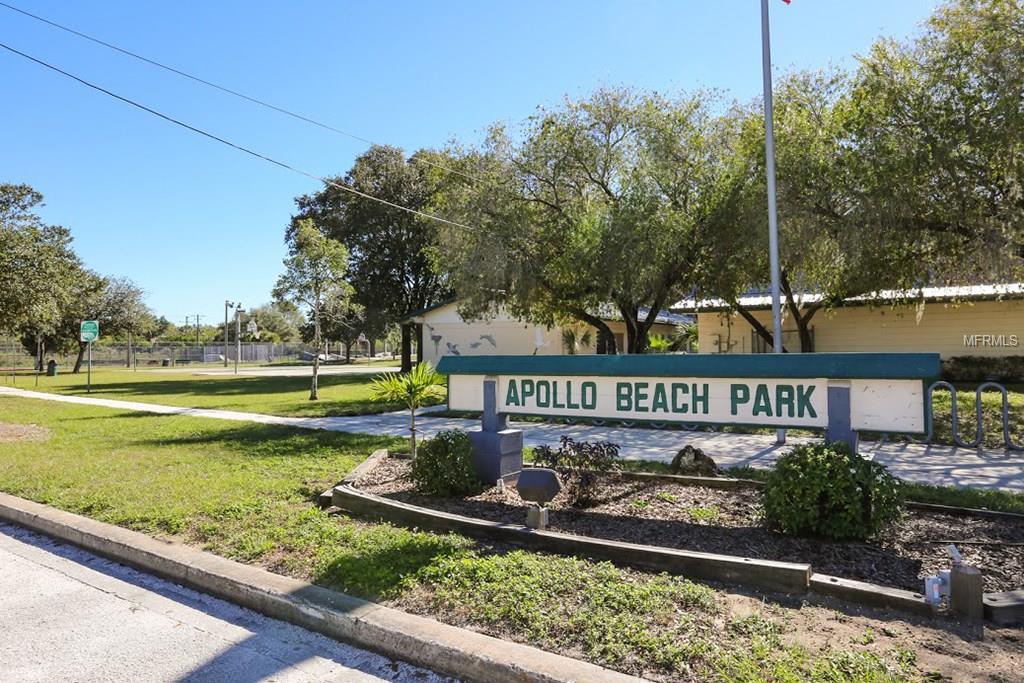 Apollo Beach Park sign with green trees.