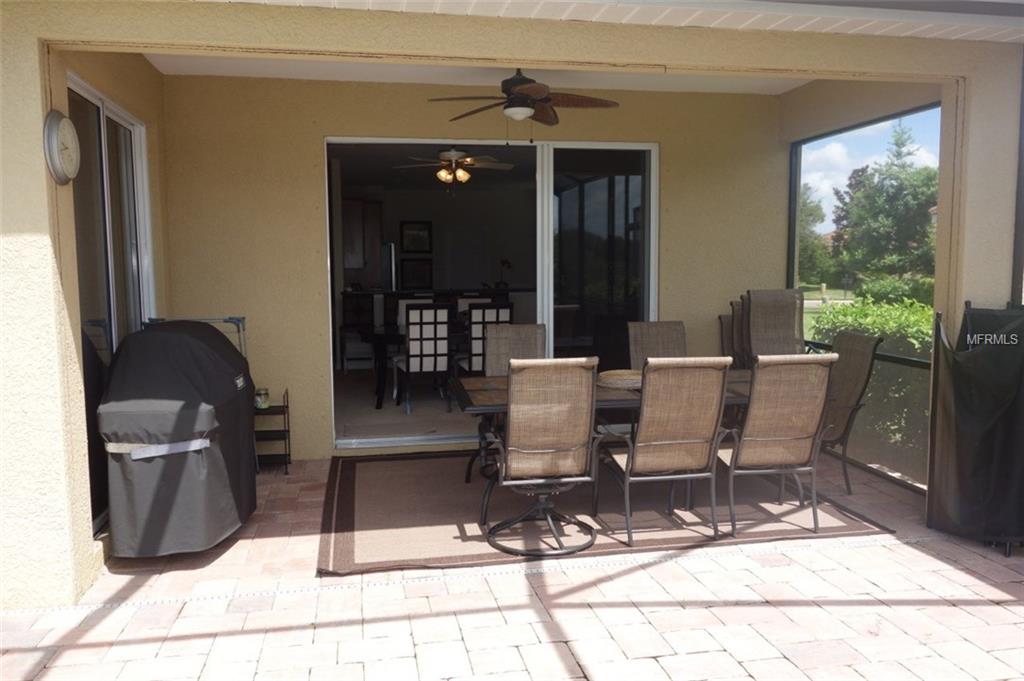 Patio with table, chairs and grill.