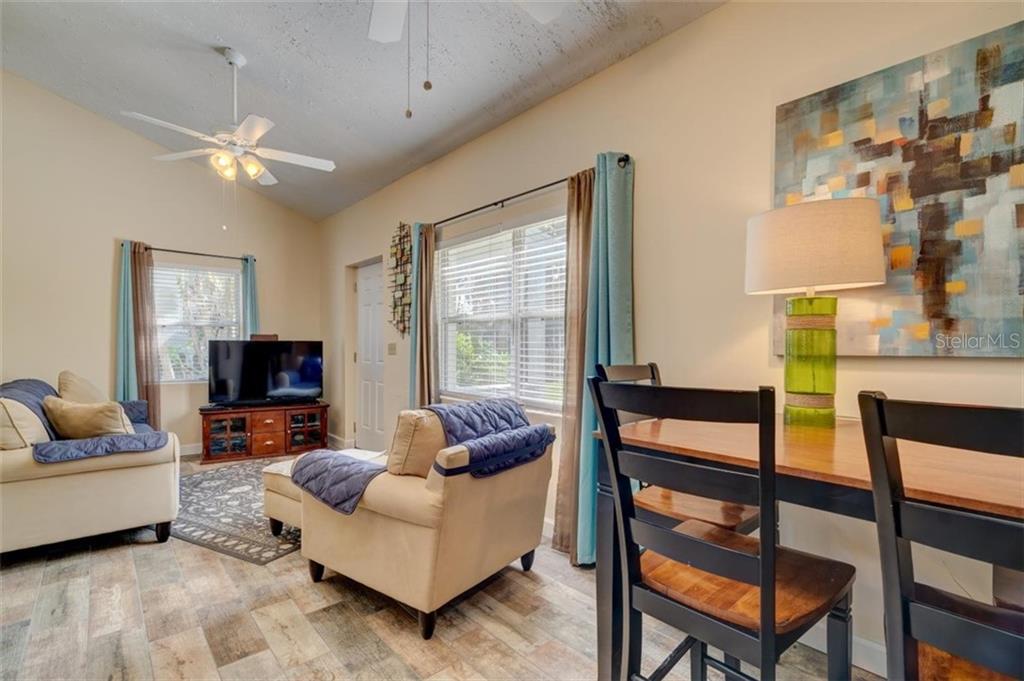 Living room with couch, chairs, and table.