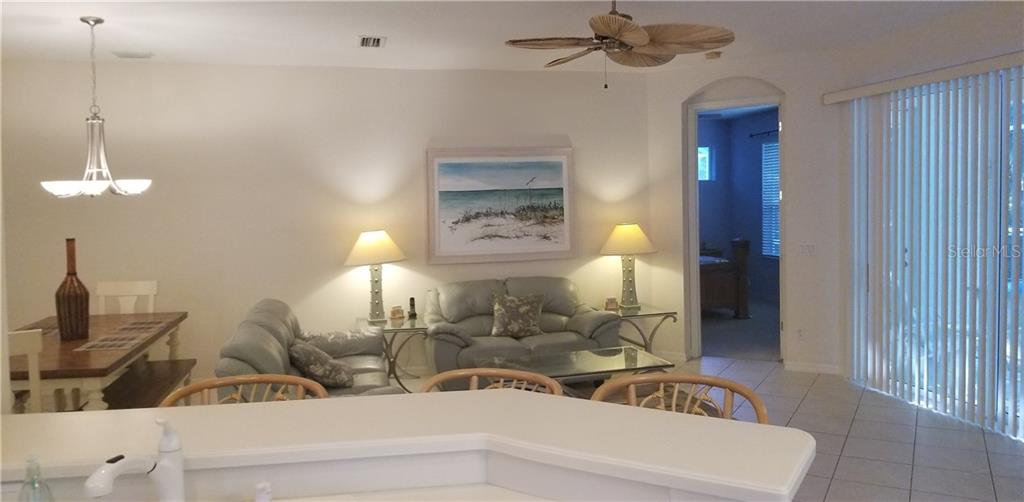 Living room with couches and a beach painting.