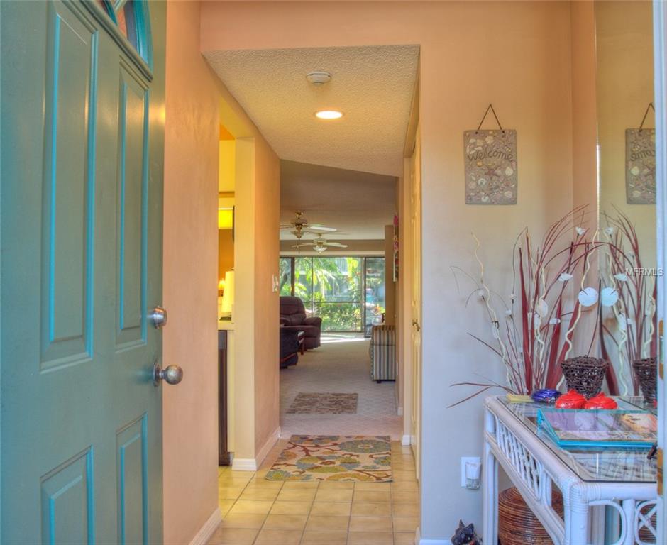 Entryway with teal door and tiled floor.