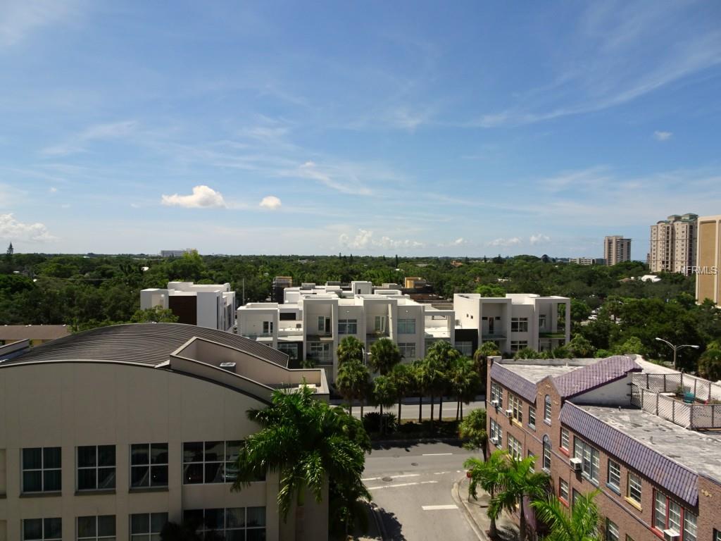 Aerial view of buildings and trees in a city.