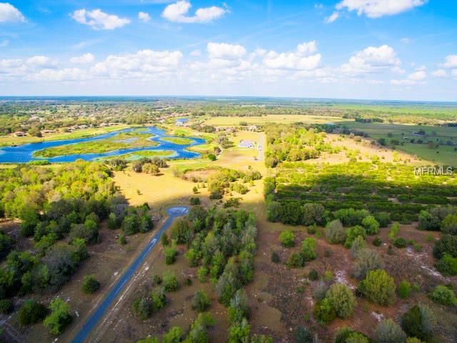 Aerial view of a rural property with a lake.