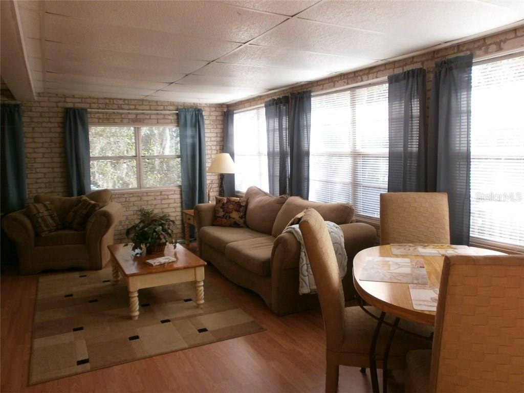 Living room with couch, chairs and table.