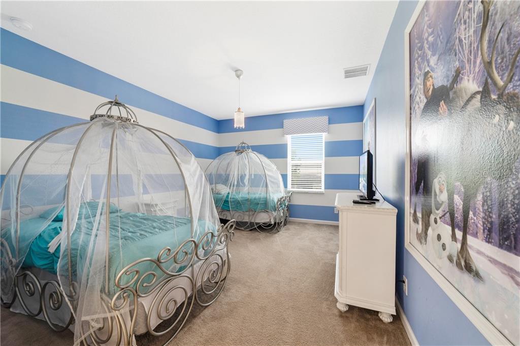 Two carriage beds in a blue and white striped room.