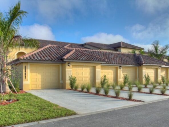 Yellow house with four garage doors.