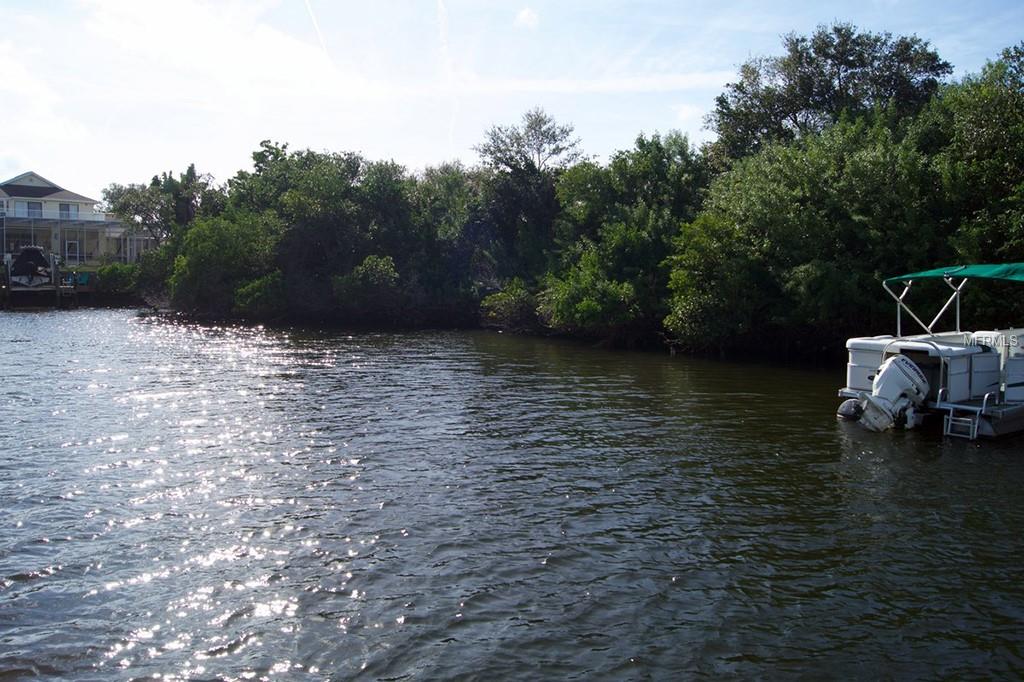 A white boat docked in a waterway.