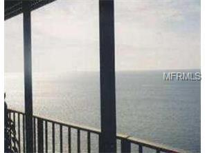 Ocean view from a balcony with railings.