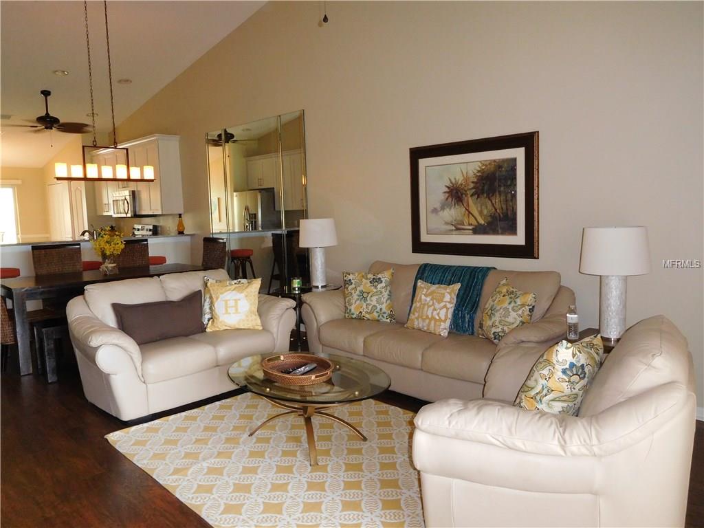 Living room with white couches and rug.