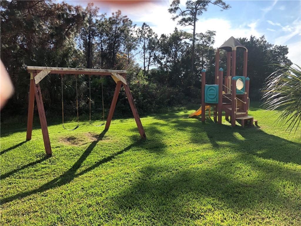 A wooden swing set and playground.