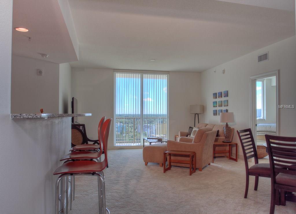 Modern condo living room with city views.