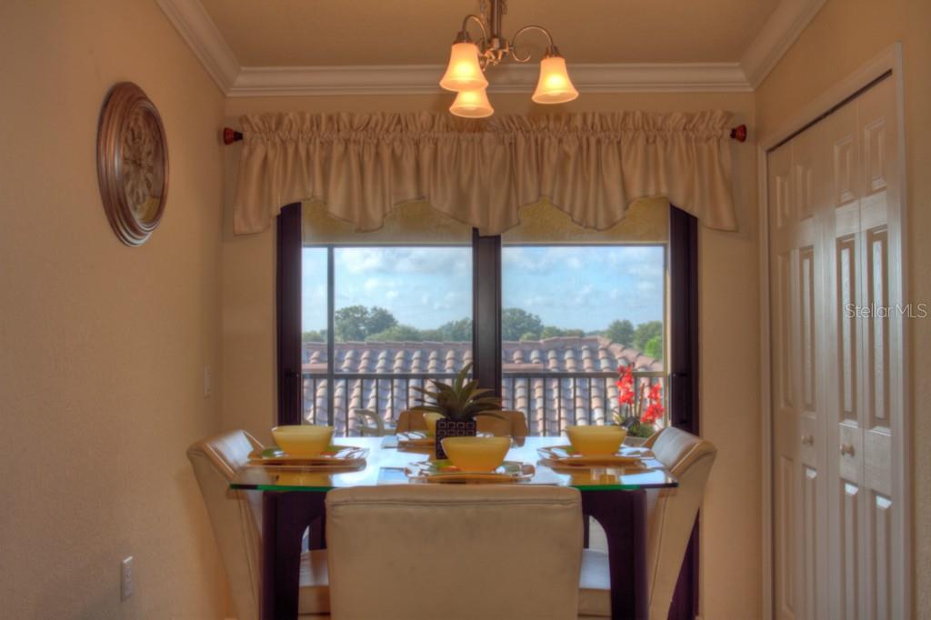 Dining room with window view and chandelier.