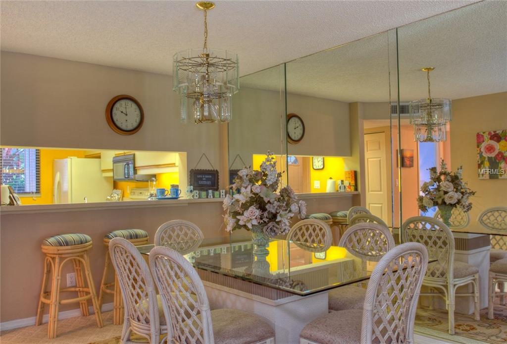 Dining room with glass table and chairs.