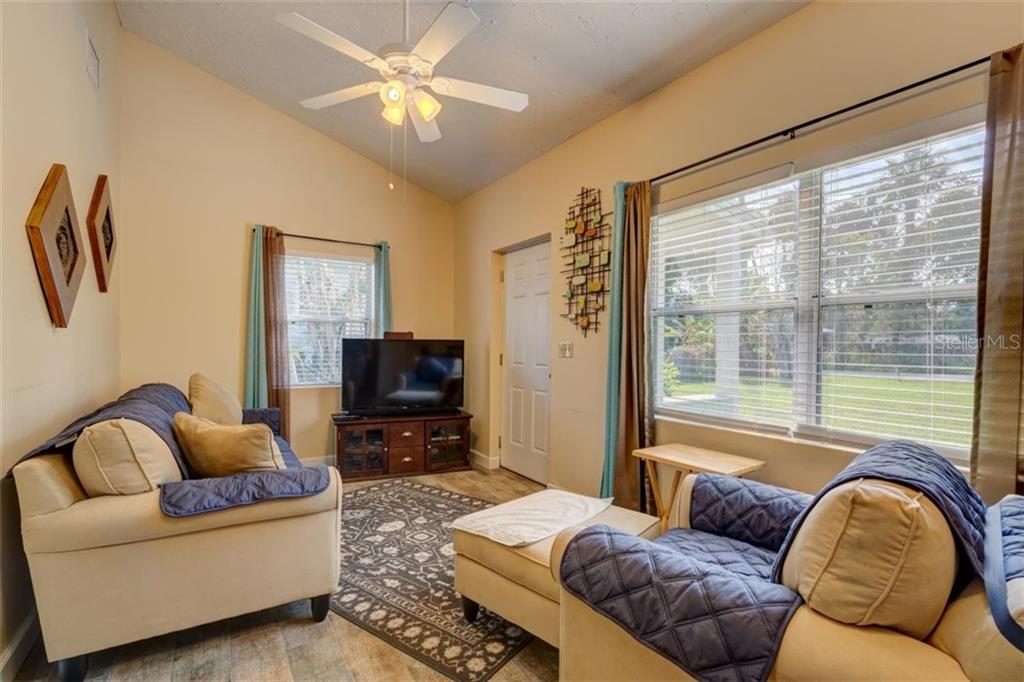 Living room with couches, TV, and window.