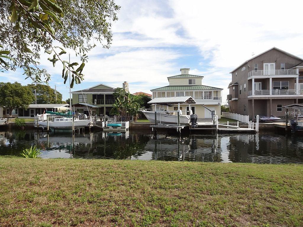 Waterfront homes with boat dock and sailboat.