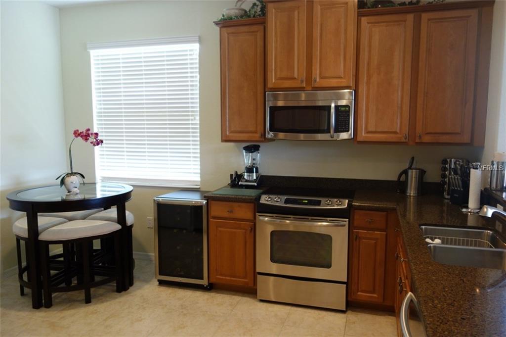 Kitchen with wood cabinets, stainless steel appliances.